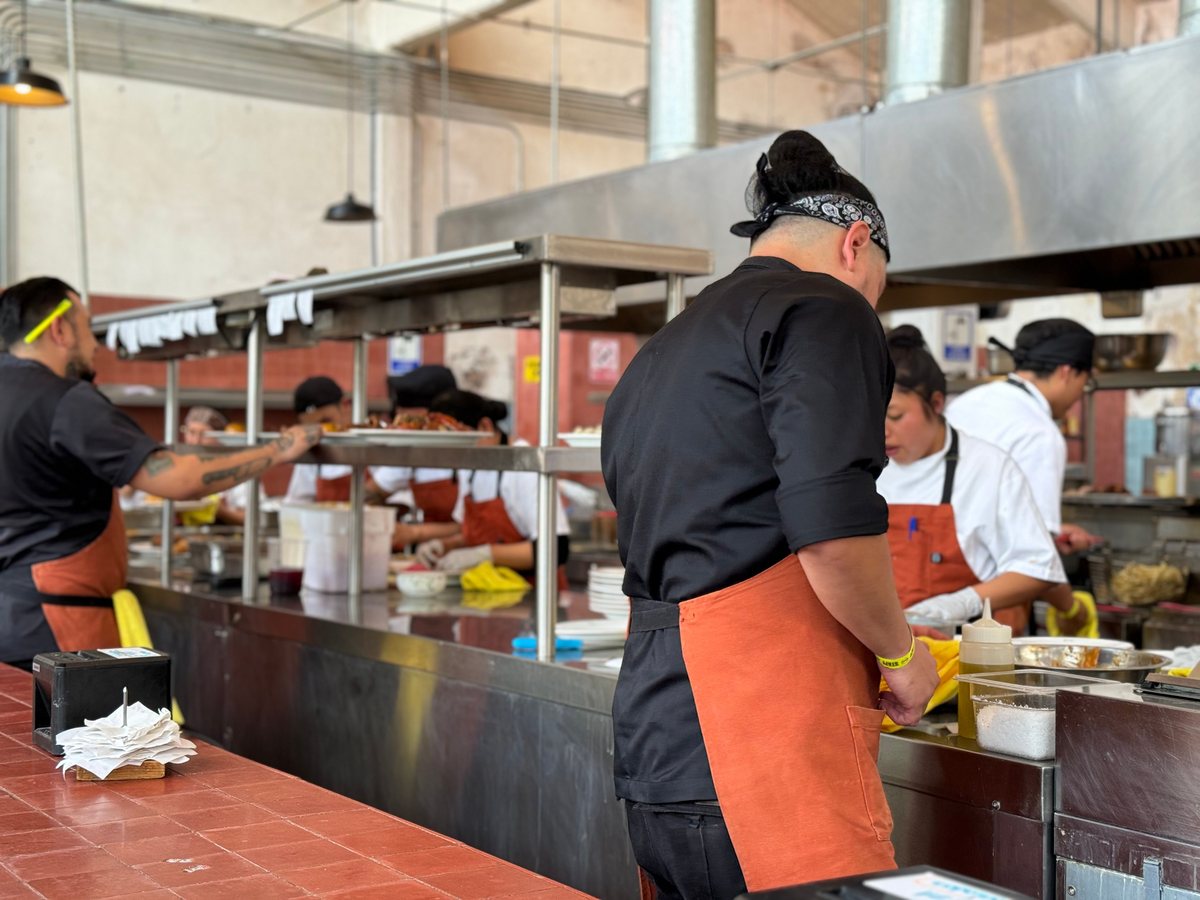 Professional chef plating food in a hotel kitchen