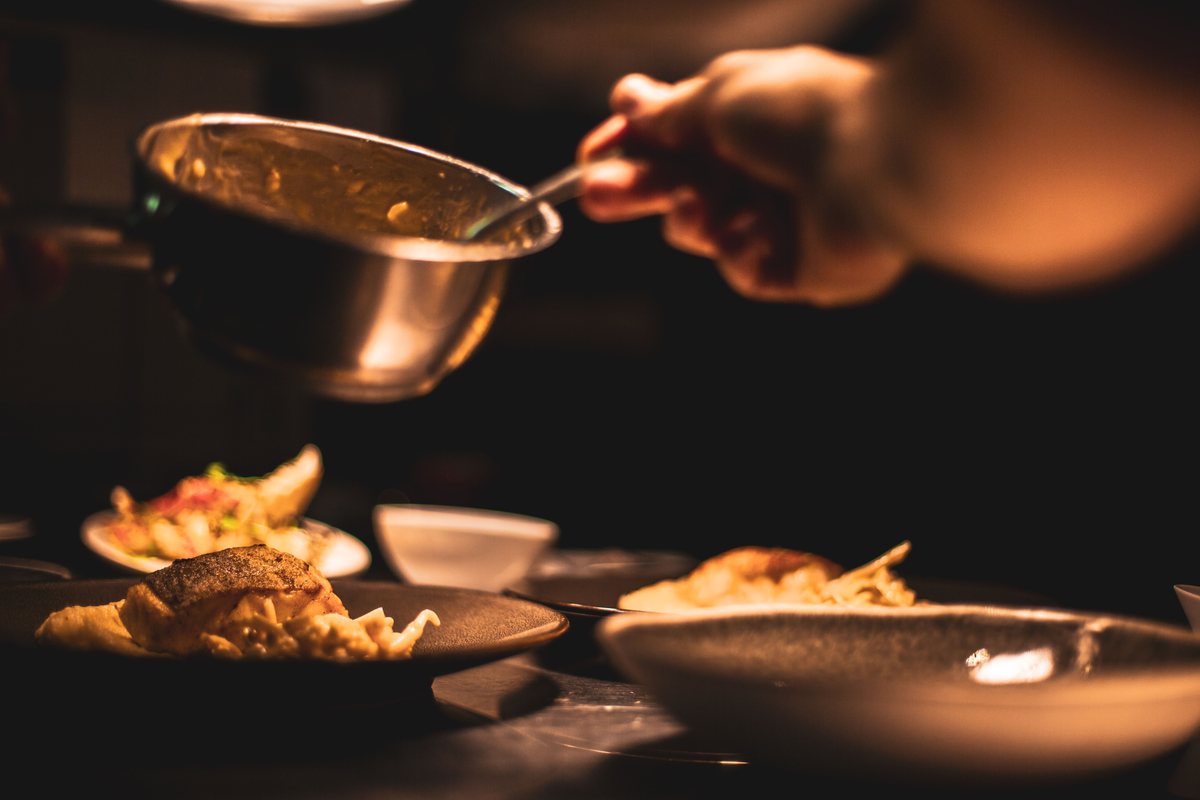 Professional chef plating food in a hotel kitchen
