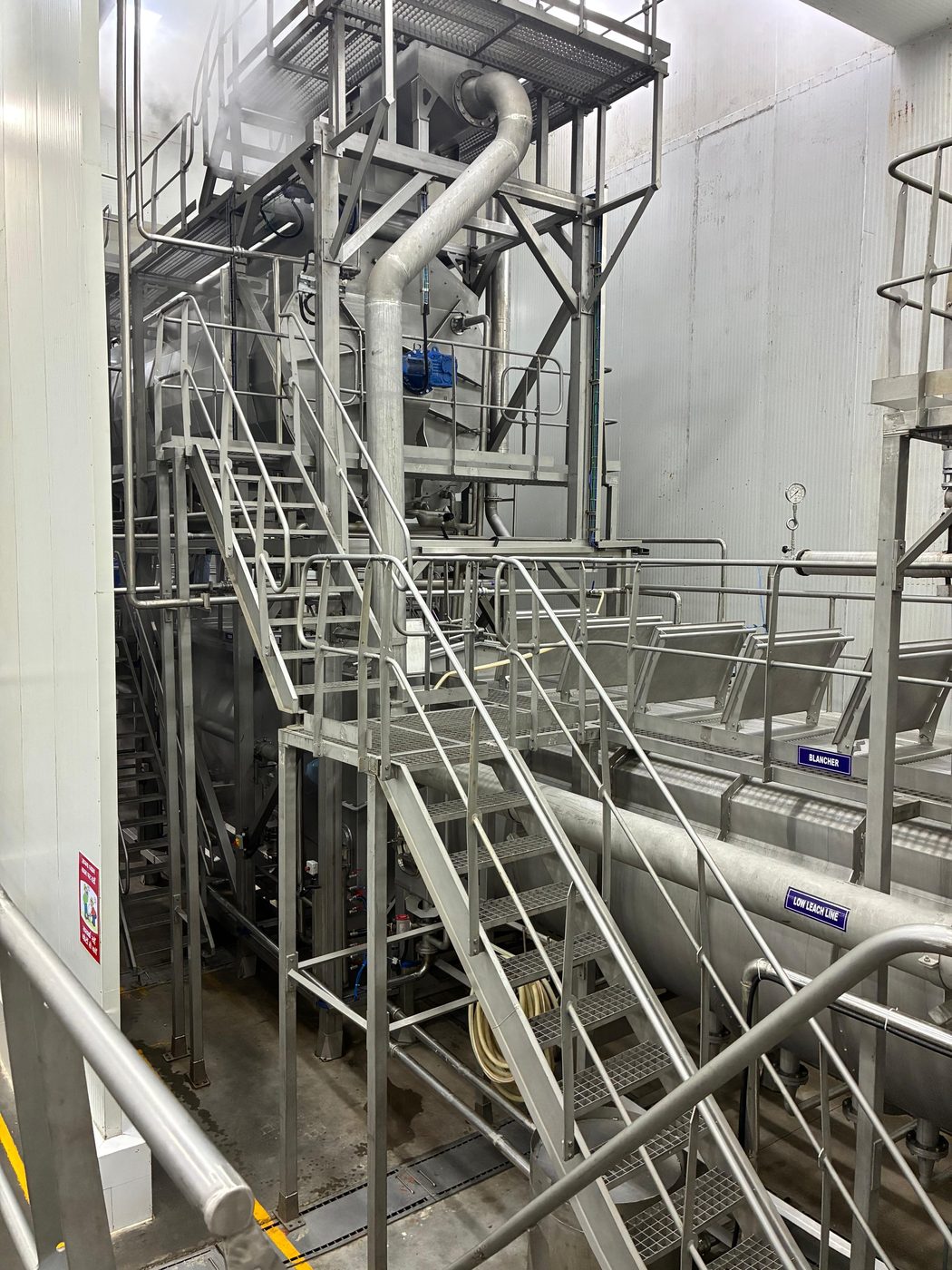 Elevated view of the potato processing line at the Furaha Foods facility, including the blancher and low leach line